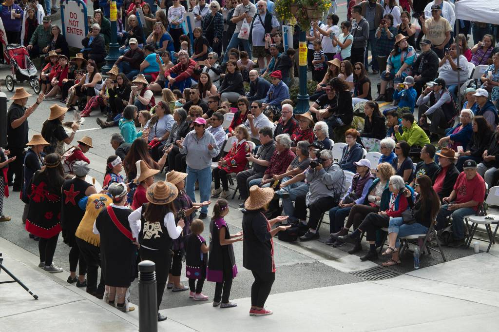 Members of the Woosh ji .een Dance Group perform during an unveiling ceremony for three bronze house posts in front of the Walter Soboleff Center by Sealaska Heritage Institute on Sunday, Aug. 26, 2018. (Michael Penn | Juneau Empire)