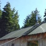 A pike pole is used to pull the old roof ladder off.