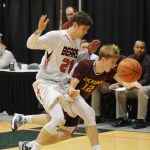 JDHS' Bryce Swafford (21) and Ketchikan’s Matt Standley collide in the game’s waning moments.