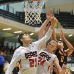 JDHS' Bryce Swofford and Erik Kelly (24) battle for a rebound with Ketchikan’s Isaac Johnson.