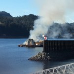 A tugboat anchored just outside Aurora Harbor burns on Monday afternoon.