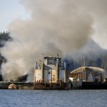 A tugboat anchored just outside Aurora Harbor burns on Monday afternoon.