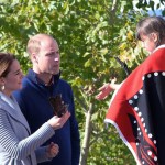 Kate, the Duchess of Cambridge holds an eagle feather given to her by a young girl as Prince William, the Duke of Cambridge, looks on during a welcoming ceremony in Carcross, Yukon, Wednesday.