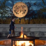 Britain's Prince William, the Duke of Cambridge, walks past a fire outside the cultural center in Whitehorse, Yukon, Tuesday.