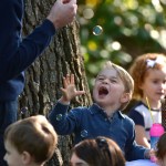 Britain's Prince George plays with bubbles during a children's tea party at Government House in Victoria, British Columbia Thursday.