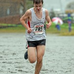 Juneau-Douglas High School's John White gives his all as he approaches the finish of Saturday's 4A Boys Region V Crosscountry Championships at Sandy Beach.