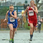 Skagway's Madison Cox and Wrangell's Helen Decker sprint to the finish of the 1A/2A/3A Girls Region V Crosscountry Championships at Sandy Beach on Saturday.