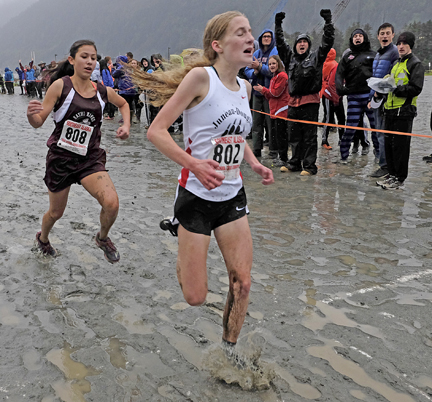 Juneau-Douglas' Maddy Handley splashes across the finish ahead of Ketchikan's Elizabeth Knight during the 4A girls Region V championships on Saturday at Sandy Beach.