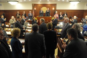 Gov. Bill Walker is greeted by legislators as he enters the House chambers for his annual State of the State address to a Joint Session of the Legislature on Thursday.