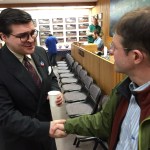 School board candidate Kevin Allen shakes hands with Assemblyman Jesse Kiehl at Election Central on Tuesday.
