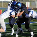 Falcons running back Roy Tupou is tackled by Palmer defenders during a state football semi-final game played in Palmer on Saturday. Palmer won 28-26.
