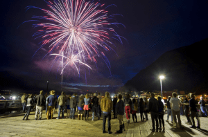 In this file photo from last month, people watch as the city's annual Fourth of July fireworks display takes place downtown.