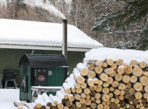 In this Mar. 27, 2009 file photo, smoke rises from the top a wood-fired boiler near a home in Fairbanks.
