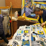In this file photo from August, mother and daughter weavers — Lily Hope, left, works on a robe as her mother, Clarissa Rizal, works on the "Weavers Across the Waters" robe.