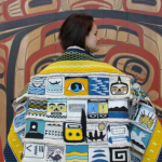 In this file photo from August, Lily Hope wears the "Weavers Across the Water" robe during its progress (the bottom had yet to be completed.) She was one of the weavers who contributed a square to the robe, which was an idea of her mother, master weaver Clarissa Rizal, who spent the last month putting the pieces together and weaving the border. Rizal passed away on Wednesday.