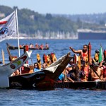 Pullers from the Puyallup Tribe head toward a landing during an annual canoe journey Wednesday in Seattle. Dozens of tribal canoes were arriving at Alki Beach in Seattle as part of an annual Native American celebration. Members of the Muckleshoot Tribe greeted the boats Wednesday afternoon as part of the 2016 Paddle to Nisqually.