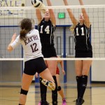 Juneau-Douglas' Maddie McKeown (14) and Kallen Hoover (11) block a spike by Ketchikan's Gabby Clark (12) during Friday's 4A Region V volleyball tournament action at Thunder Mountain High School.