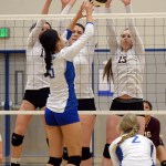 Thunder Mountain's Maxie Saceda-Hurt (5) tips a ball past Ketchikan's Kreylynn Johnson, Kinani Halvorsen and Havalah Clark (13) during Friday's opening game of the 4A Region V volleyball tournament at TMHS.