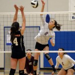 Ketchikan's Kaia Michalsen (8) kills a shot against Juneau-Douglas' Leah Spargo (4) during the 4A Region V volleyball tournament at Thunder Mountain High School in Juneau.