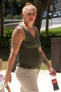 In this May 22, 2015 file photo, Samantha Leialoha Watanabe walks outside of federal court in Honolulu. On Tuesday, Dec. 8, 2015, a federal jury found her guilty of assaulting her 15-month-old daughter on a flight from Alaska in May. Prosecutors say Watanabe cursed at her daughter, smacked her in the head, hit her in the face with a stuffed doll and yanked out tufts of her hair. They say passengers and flight attendants on the May 3 Alaska Airlines flight believed Watanabe was unnecessarily rough to a generally well-behaved toddler.