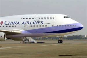 In this Jan. 26, 2003, file photo, a China Airlines Boeing 747-400 sits on the tarmac at the Chiang Kai-shek International airport in Taoyuan, Taiwan. A woman deported to her homeland Taiwan after giving birth on a China Airlines flight on Oct. 8, 2015, to the U.S. in an apparent attempt to give her baby American citizenship may have to pay hefty compensation for forcing the plane to divert.