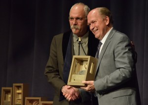 Bob Banghart of Juneau accepts a Distinguished Service to the Humanities award from Gov. Bill Walker on Thursday night 2017 at the Juneau Arts and Culture Center during the 2017 Governor&rsquo;s Awards for the Arts and Humanities. (James Brooks | Juneau Empire)