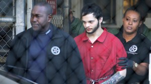 Esteban Santiago, center, is led from the Broward County jail for an arraignment in federal court, Monday, Jan. 30, 2017, in Fort Lauderdale, Fla. Santiago is charged in a 22-count federal indictment in the Jan. 6 shooting at the Fort Lauderdale-Hollywood International Airport. (Lynne Sladky | The Associated Press)