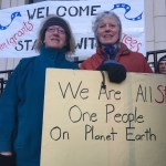 From left, Cathy Botelho and Judith Maier at the &ldquo;Stand with Refugees and Immigrants&rdquo; event Monday morning. This was the second gathering organized in front of the Alaska State Capitol, aimed both at showing support for refugees and immigrants and thanking Alaskan legislators who have spoken out against President Donald Trump&rsquo;s executive order. (Mary Catharine Martin | Juneau Empire)