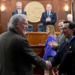 Alaska Supreme Court Chief Justice Craig Stowers is greeted as he arrives for his State of the Judiciary address before a joint session of the Alaska Legislature at the Capitol on Wednesday. Senate President Pete Kelly, R-Fairbanks, left, and Speaker of the House Bryce Edgmon, D-Dillingham, watch from the Speakers desk in the background. (Michael Penn | Juneau Empire)