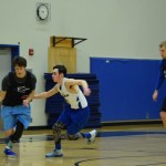Thunder Mountain high school&rsquo;s Noah Reishus-O&rsquo;Brien drives past teammate Kaiden Ward as Riley Olsen looks on Wednesday, Feb. 8 at TMHS. (Nolin Ainsworth | Juneau Empire)