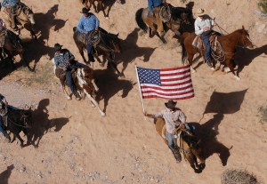 In this April 12, 2014 photo, the Bundy family and their supporters fly the American flag as their cattle is released by the Bureau of Land Management back onto public land outside of Bunkerville, Nev. A federal judge in Nevada is considering crucial rulings about what jurors will hear in the trial of six defendants accused of stopping U.S. agents at gunpoint from rounding up cattle near Cliven Bundy&rsquo;s ranch in April 2014. (Jason Bean | Las Vegas Review-Journal)