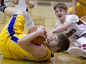 Juneau-Douglas&rsquo; Kolby Hoover, right, wrestles with Lathrop&rsquo;s Jake Carlson for the ball at JDHS on Friday, Feb. 10, 2017. JDHS won 50-43. (Michael Penn | Juneau Empire)