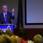 University of Alaska president Jim Johnsen delivers his State of the University address to the Juneau Chamber of Commerce on Thursday in the Hangar Ballroom. (James Brooks | Juneau Empire)