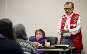 Percy Kunz watches her husband, Ed, as he speaks about his jewelery making during the University of Alaska Southeast&rsquo;s Art of Place on Friday, Feb. 17, 2017.