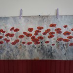 &ldquo;The poppies&rdquo; by Nancy Day hang for viewing before the piece was divided up at Petersburg&rsquo;s Art by the Inch fundraiser. (Photo by Chelsea Tremblay)