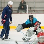 Gary Stephens, right, gets attention from Wylie Rogers, of Alaska Goaltending Academy, during a goaltending workshop at Treadwell Arena on Wednesday. (Michael Penn | Juneau Empire)