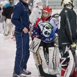 Mason Sooter, right, gets attention from Wylie Rogers, of Elite Goaltending, during a goaltending workshop at Treadwell Arena on Wednesday. (Michael Penn | Juneau Empire)