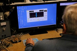 In this Feb. 21 photo, lifelong ham radio operator and expert tinkerer Tom Thompson, looks at a representation of radio waves on his computer inside his basement home office in Boulder, Colorado, where he operates a ham radio and other devices. After discovering that radio interference was being caused by high-powered lights from home marijuana growers, Thompson built an electronic filter and has given them to nearby growers. (Brennan Linsley | The Associated Press)