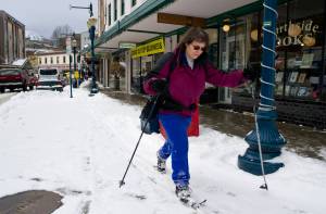 Jodie Pessolano takes advantage of recent snow to ski along Front Street on Thursday. (Michael Penn | Juneau Empire)