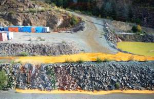 The Tulsequah Chief Mine is seen on Sept. 26, 2016. The yellow water is Acidic Mine Drainage from shuttered mine adits. It drains into an &ldquo;exfiltration pond,&rdquo; pictured, which overflows into the Tulsequah River. (Courtesy Photo)