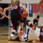 Juneau-Douglas&rsquo; Caitlin Pusich escapes with the ball as Thunder Mountain&rsquo;s Charlee Lewis takes a tumble at TMHS on Friday, March 3, 2017. JDHS won 49-42. (Michael Penn | Juneau Empire)