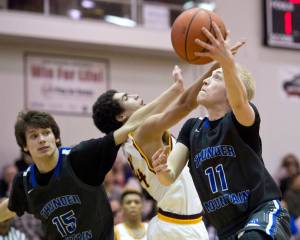 Thunder Mountain&rsquo;s Chase Saviers, right, as teammate Noah Reishus-O&rsquo;Brien, right, blocks out Ketchikan&rsquo;s Shakim Bauer during the 4A Regional V Basketball Tournament at JDHS on Wednesday. Ketchikan won 65-44. (Michael Penn | Juneau Empire)