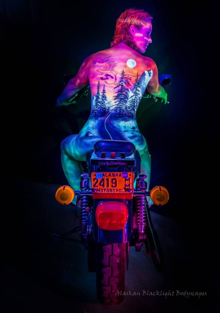 A woman bikes down a mysterious highway. Photo by Ron Gile.