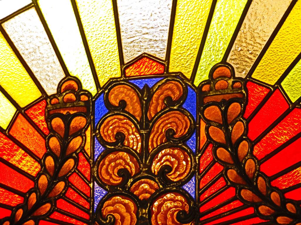 Stained glass decoration seen above one of the entrances to the Exchange Building in Seattle. Photo by Ray Tsang.
