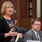 Sen. Anna MacKinnon, R-Eagle River, speaks in favor of SB 26 as Sen. Lyman Hoffman, D-Bethel, listens in the Senate chambers on Wednesday. The Senate voted to use a portion of earnings from the Alaska Permanent Fund to fund government and cap dividends at $1,000 per person. (Michael Penn | Juneau Empire)