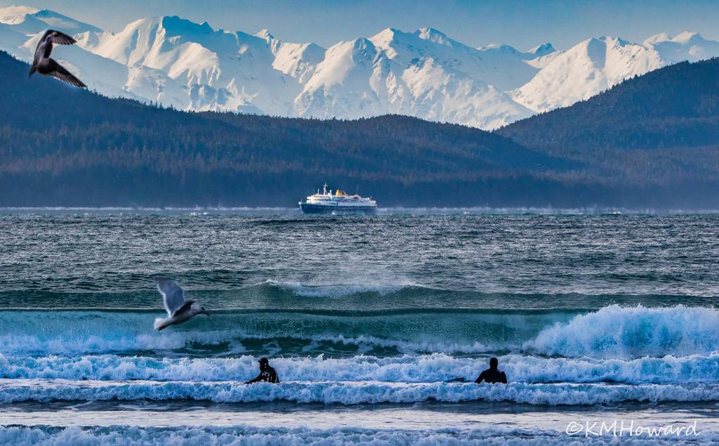 Intrepid surfers wait for the next big wave at Lena Cove on March 7. (Photo by Kerry Howard)