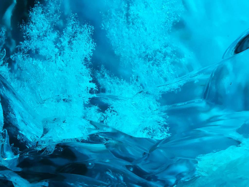 An explosion of air bubbles in the ice cave. Photo by Denise Carroll.