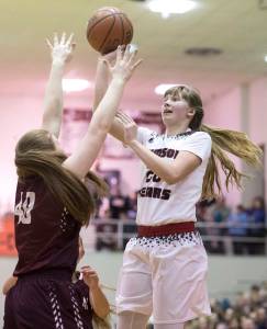Juneau-Douglas&rsquo; Caitlin Pusich shoots against Ketchikan&rsquo;s Sarah McClennan during the Region V Basketball finals at JDHS on March 10. (Michael Penn | Juneau Empire)