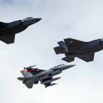 This Sept. 2, 2015 photo shows an F-16, below, escorting two F-35 jets, above, after arriving the latter arrived at Hill Air Force Base in Utah. The U.S. and its Asia-Pacific allies are rolling out their new stealth fighter jet, a cutting-edge plane that costs about $100 million each. (Rick Bowmer | The Associated Press File)