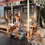 Atticus takes aim at a mad dog. Left to right, Seth Coppens (Scout), Forrest Davis (Jem), Diane Fleeks (Calpurnia) on porch. On the ground are Jamie Nelson (Heck Tate and Enrique Bravo (Atticus Finch). Photo by Julie Coppens.